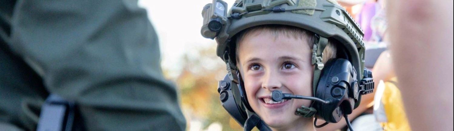 A child wearing a police uniform